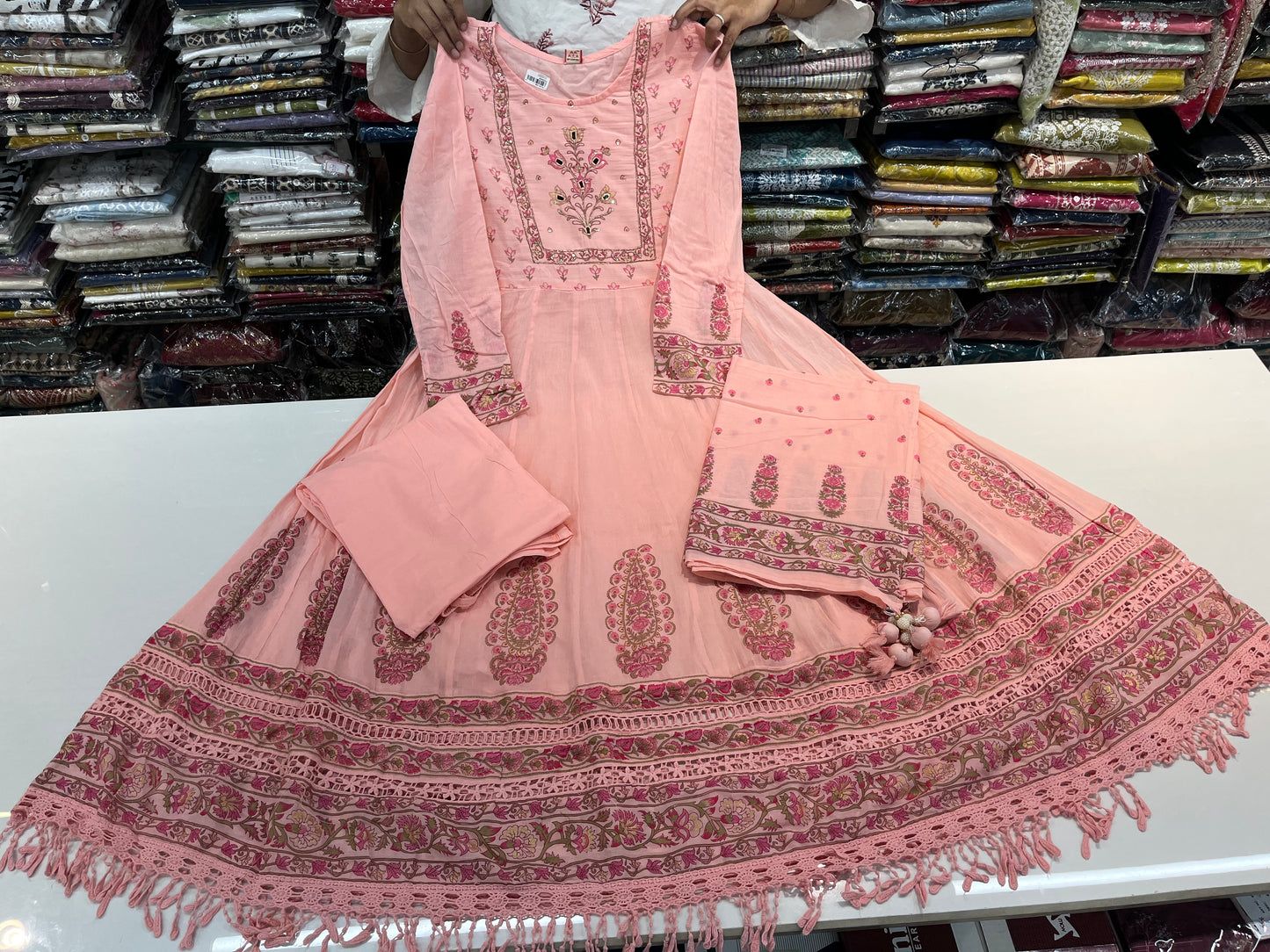 'ROYAL PEACHES' Premium mull cotton anarkali suit set with beautiful hand embroidery detailings on neckline and a premium cotton crotia lace work on all over its flare (along with pants and a block print mulmull dupatta with fourside latkans)