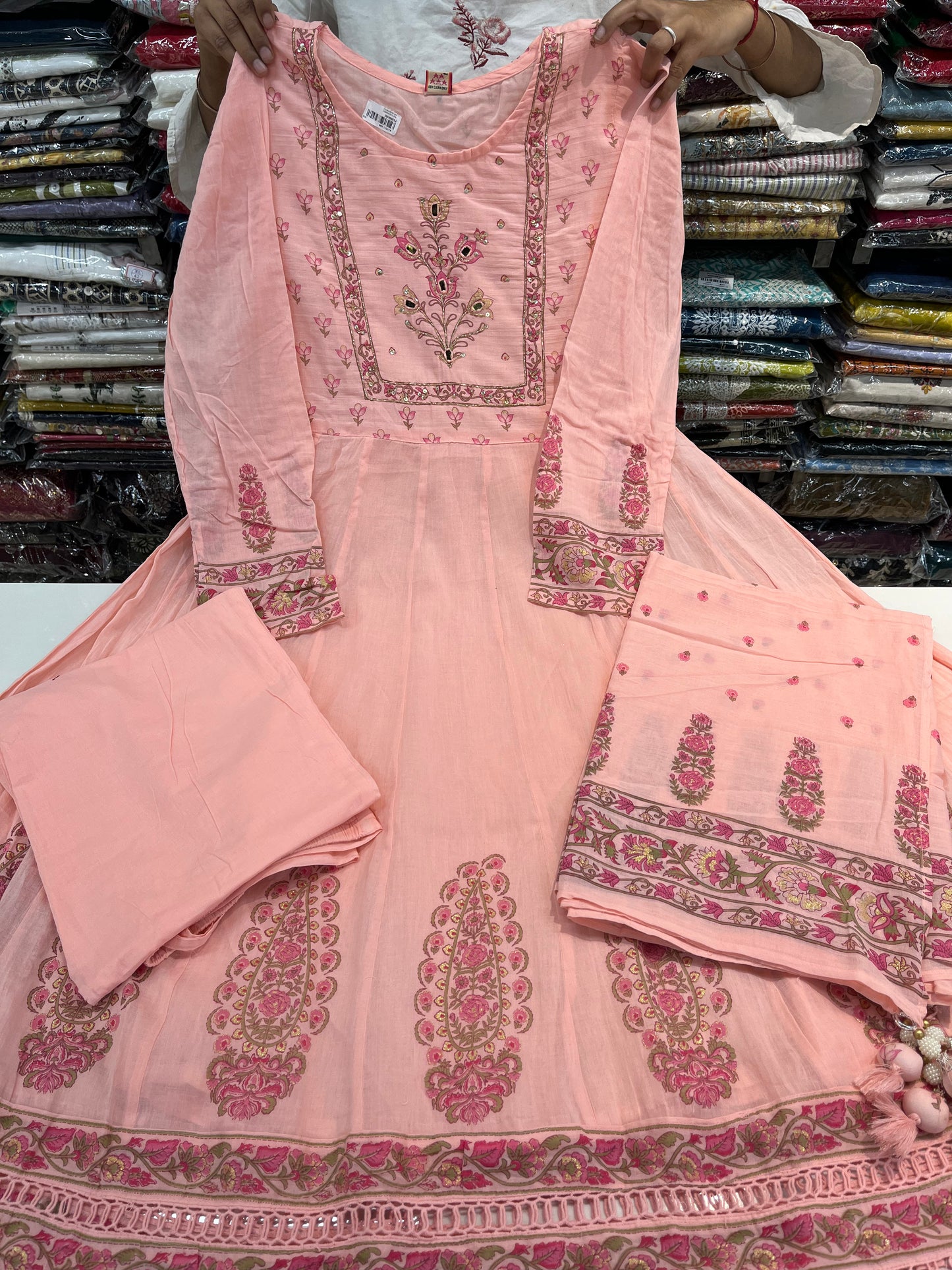 'ROYAL PEACHES' Premium mull cotton anarkali suit set with beautiful hand embroidery detailings on neckline and a premium cotton crotia lace work on all over its flare (along with pants and a block print mulmull dupatta with fourside latkans)