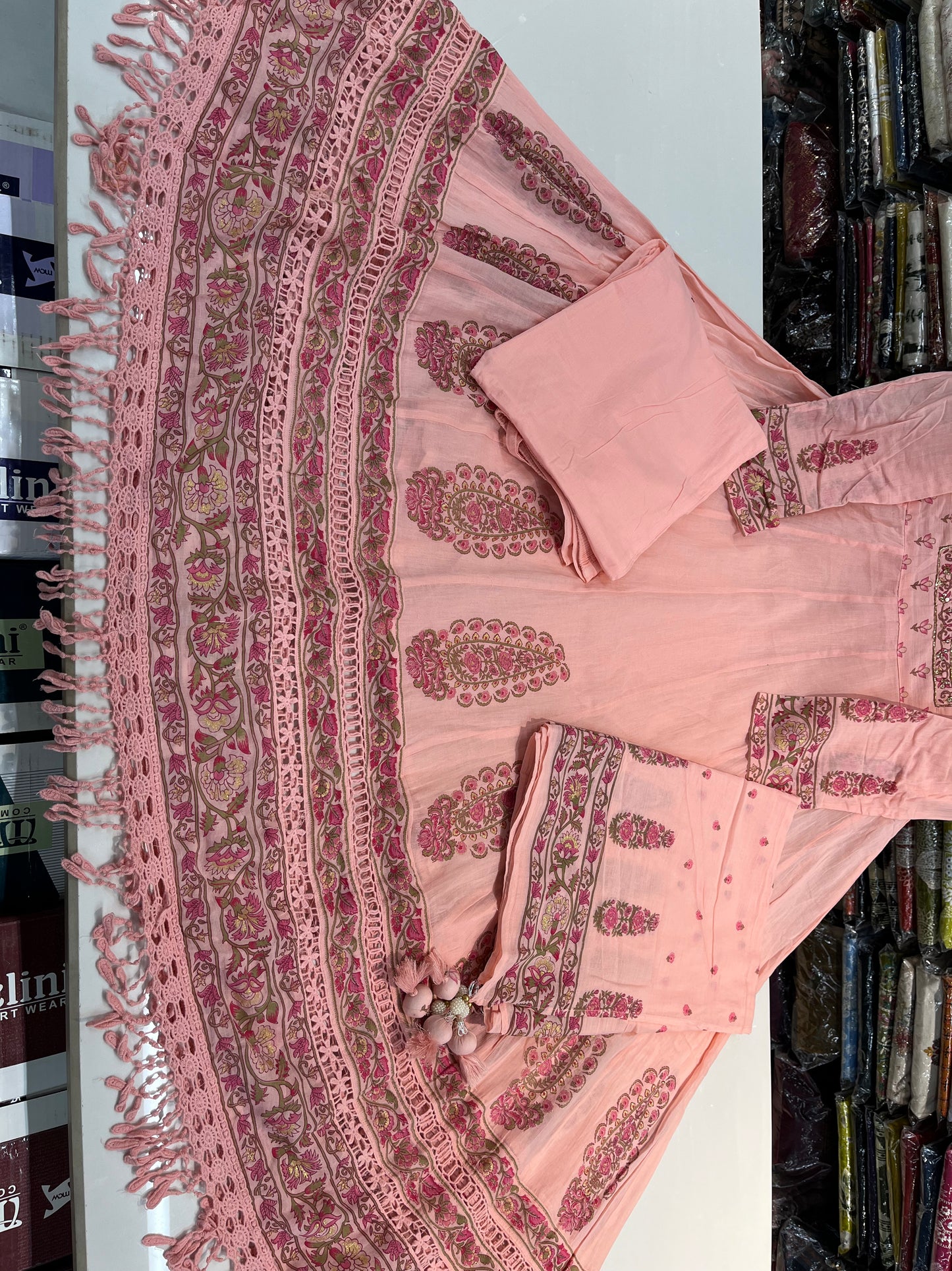 'ROYAL PEACHES' Premium mull cotton anarkali suit set with beautiful hand embroidery detailings on neckline and a premium cotton crotia lace work on all over its flare (along with pants and a block print mulmull dupatta with fourside latkans)